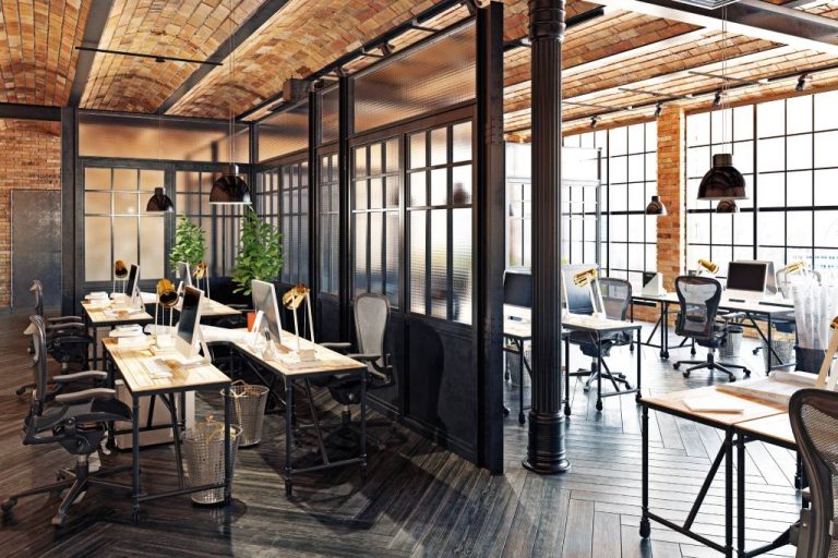 A modern office space using a mix of adaptive reuse and industrial-style design elements, such as exposed bricks and pipes.