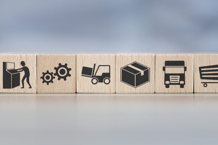 Eight small wooden blocks stacked next to each other. Each block has a different icon related to supply chain management.