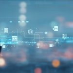 A man in a business suit holds his hands as if cradling the digital graphic representing web and cloud operations.