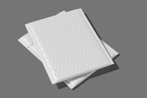 Two empty, white insulated mailers sit on a plain dark-gray background. The mailers are stacked on top of each other.