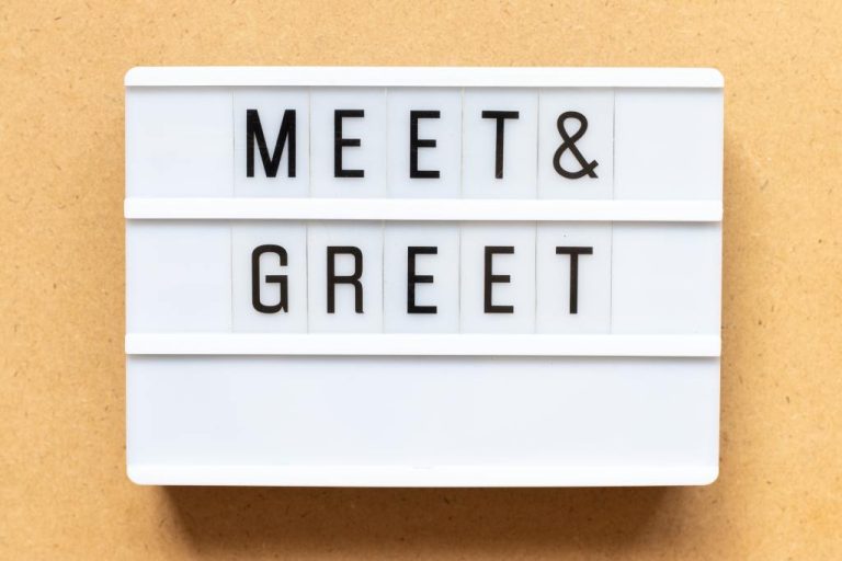 A white text display lightbox with black letters on translucent plastic spelling out the phrase "Meet & Greet".