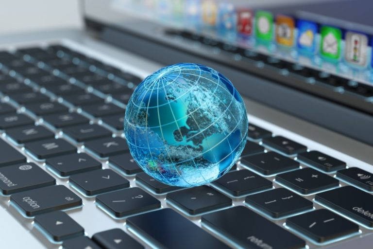 A globe icon sits on a laptop keyboard. The globe represents reliable internet connection and speeds.